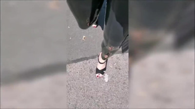 Girl wearing latex leggings and high heels in public