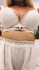 Blonde drops bra to reveal big tits