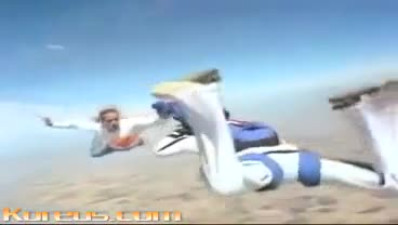 Maniac Skydives While Holding A Parachute