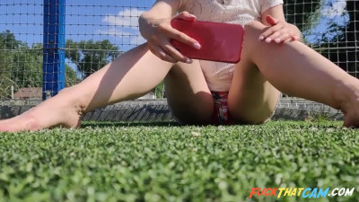 Pregnant Russian babe masturbates in public football court