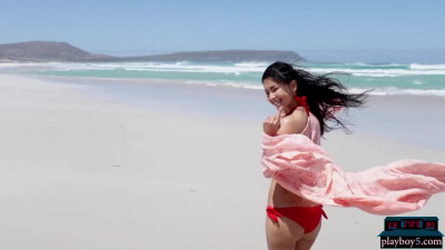 Petite Asian MILF model Chloe Rose gives a bikini striptease on the beach